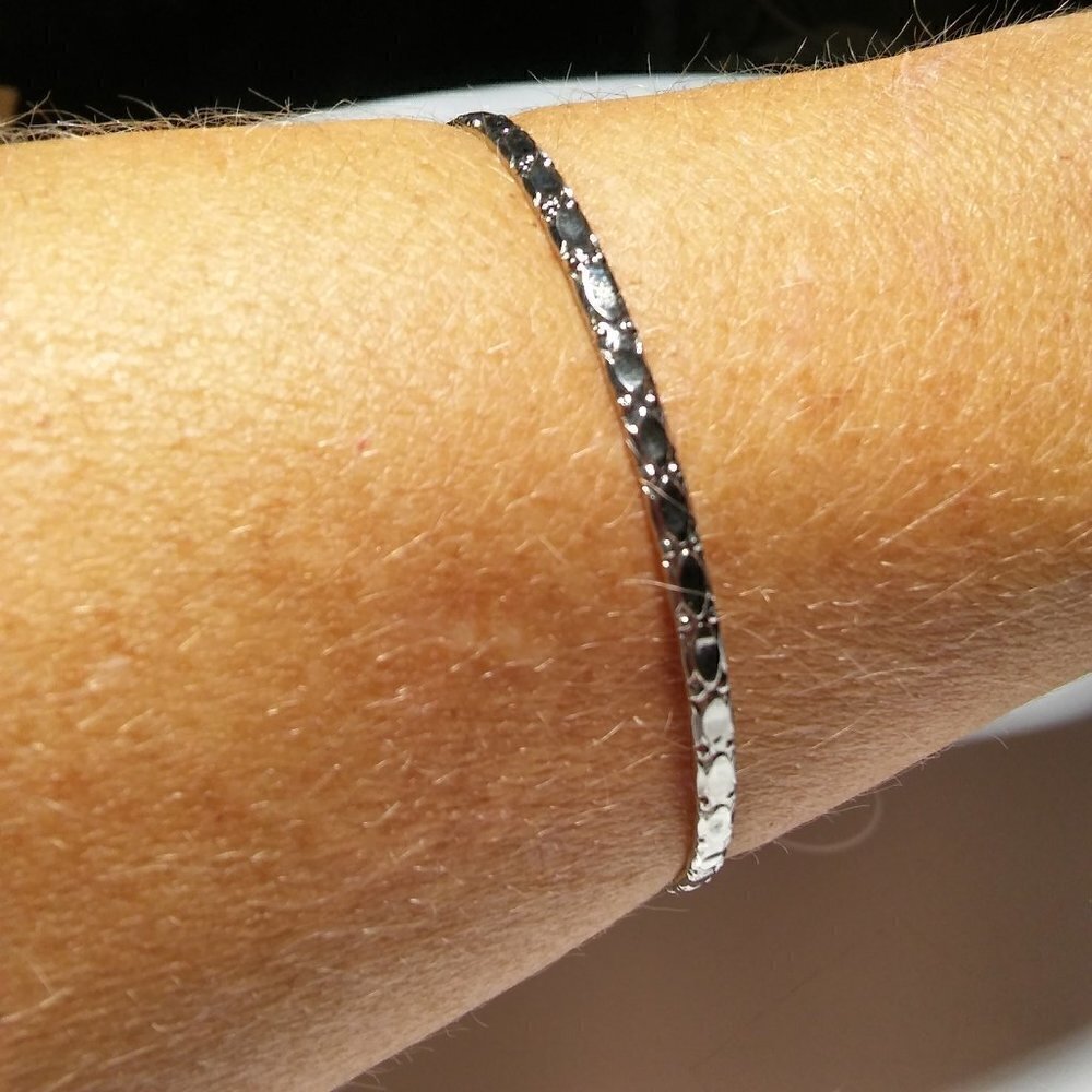 Women`s silver tone bangle bracelet. 2 1/2 inches